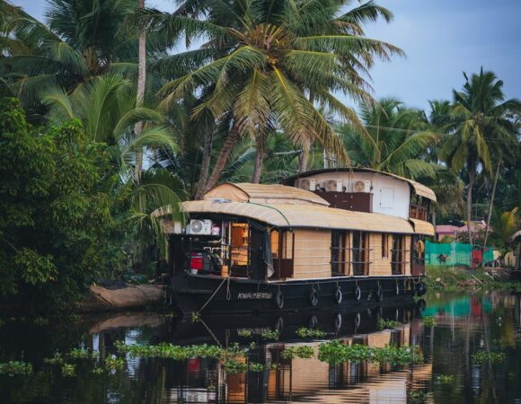 Houseboat moored on a tranquil Kerala backwater during monsoon season